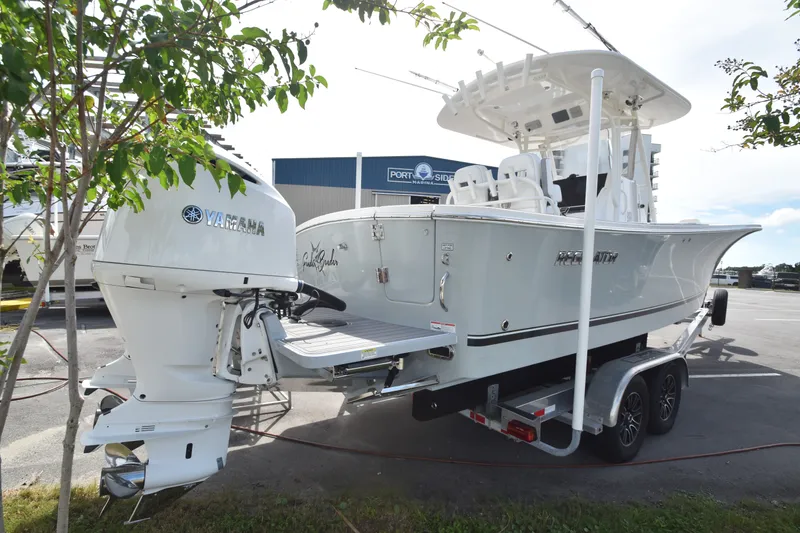 Slide: The Image of A 2018 Regulator 28 Forward Seating boat on a trailer, featuring a Yamaha outboard motor. - 2