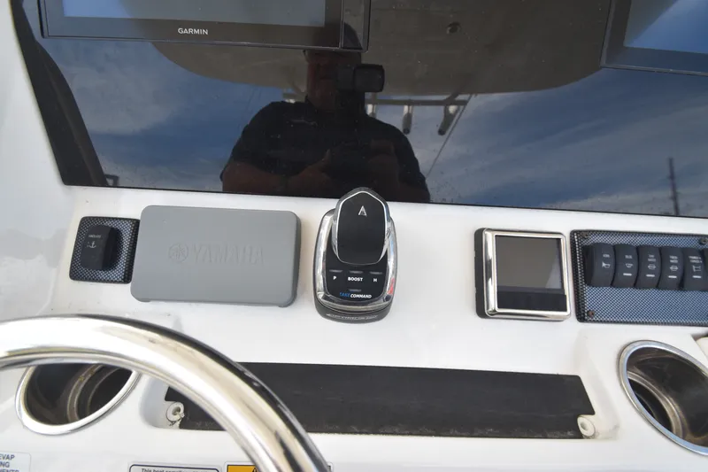 Slide: The Image of The image shows the helm of a 2018 Regulator 28 Forward Seating boat with Yamaha controls. - 9