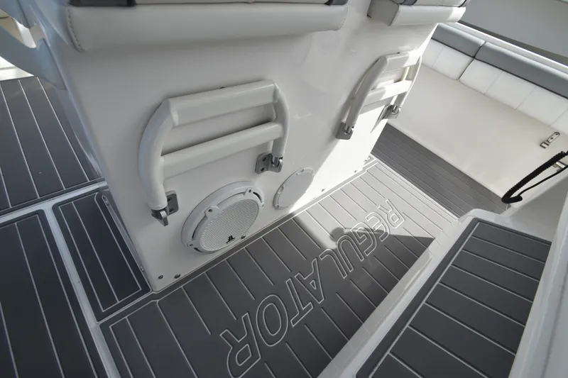 Slide: The Image of The image shows the deck of a 2018 Regulator 28 Forward Seating boat with gray upholstery. - 15