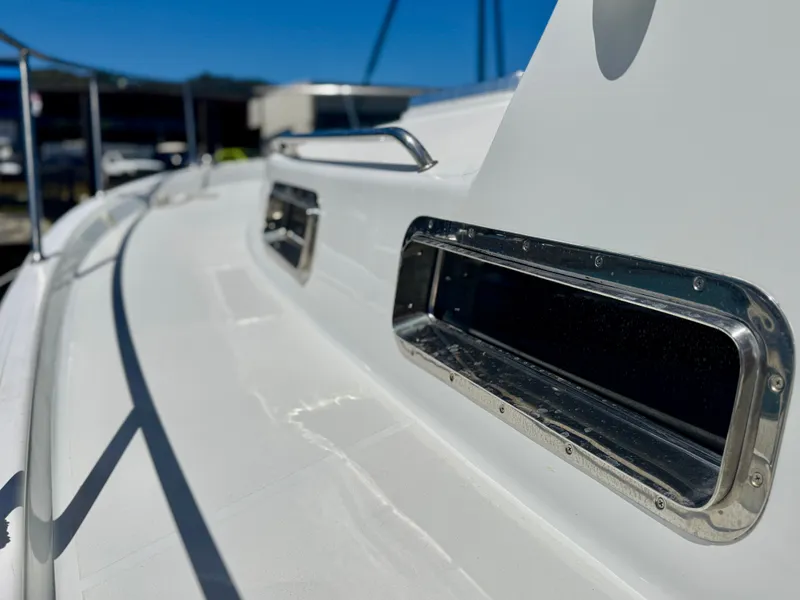 Slide: The Image of Close-up of a 2003 Legacy 34 Express deck with stainless steel windows. - 7