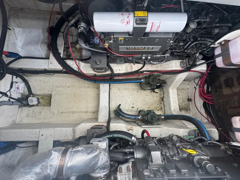 Slide: The Image of The engine room of a 2003 Legacy 34 Express shows complex machinery and wiring. - 41