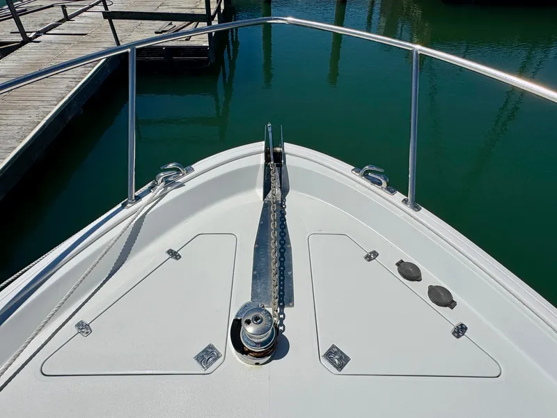 Slide: The Image of Bow view of the 2003 Legacy 34 Express with anchor windlass and stainless steel railing. - 8