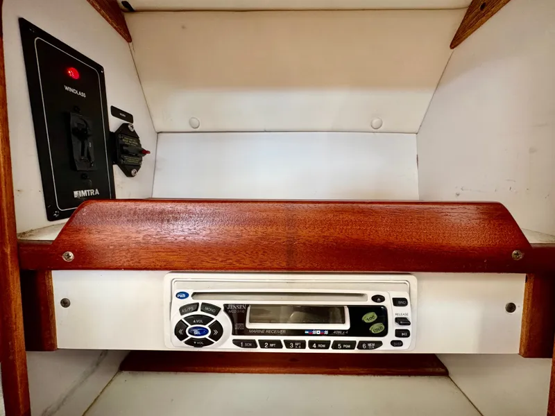 Slide: The Image of A wooden shelf with a built-in marine radio and an electrical control panel beside it. - 35