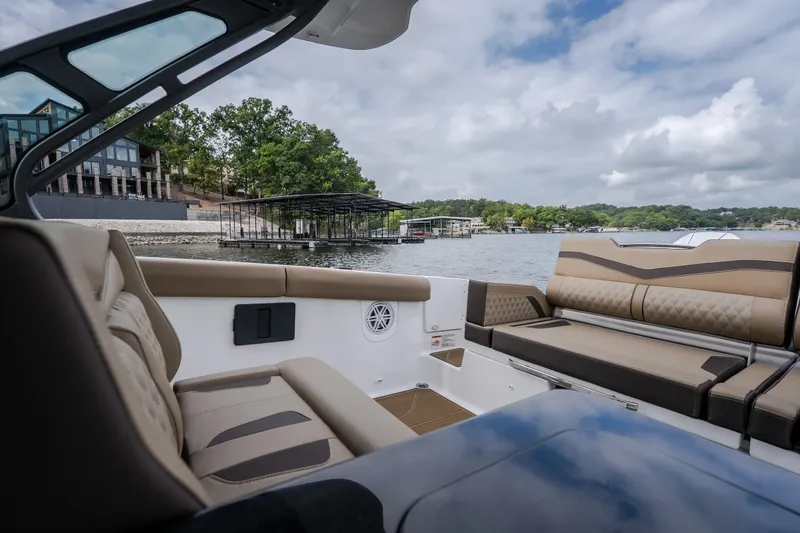 Slide: The Image of Luxurious interior of 2026 Monterey Elite 30 OB boat on a scenic lake. - 10
