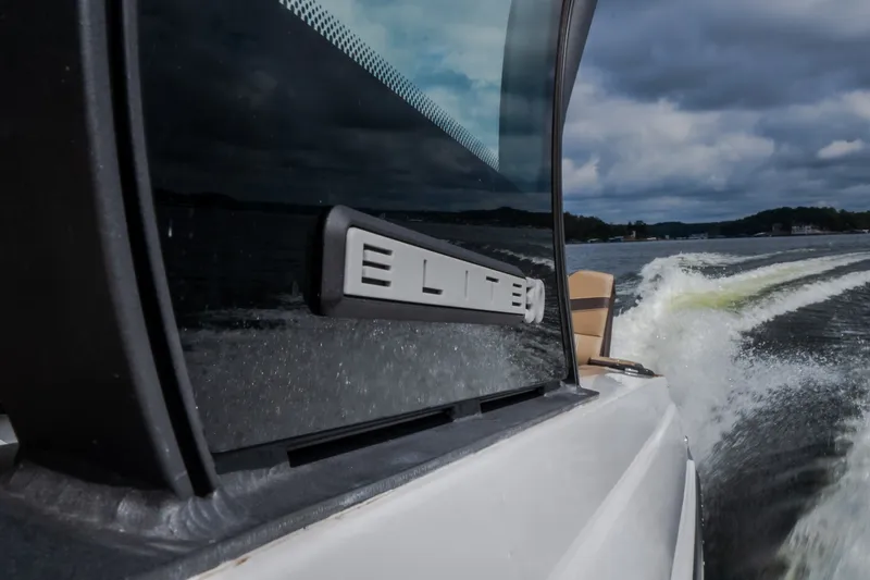 Slide: The Image of 2026 Monterey Elite 30 OB boat cruising on a lake under cloudy skies. - 54