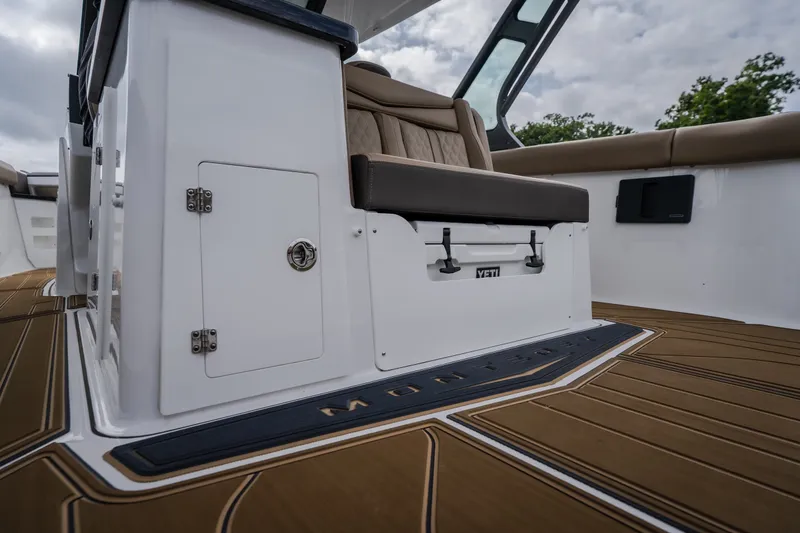 Slide: The Image of 2026 Monterey Elite 30 OB boat interior with seating and storage. - 11