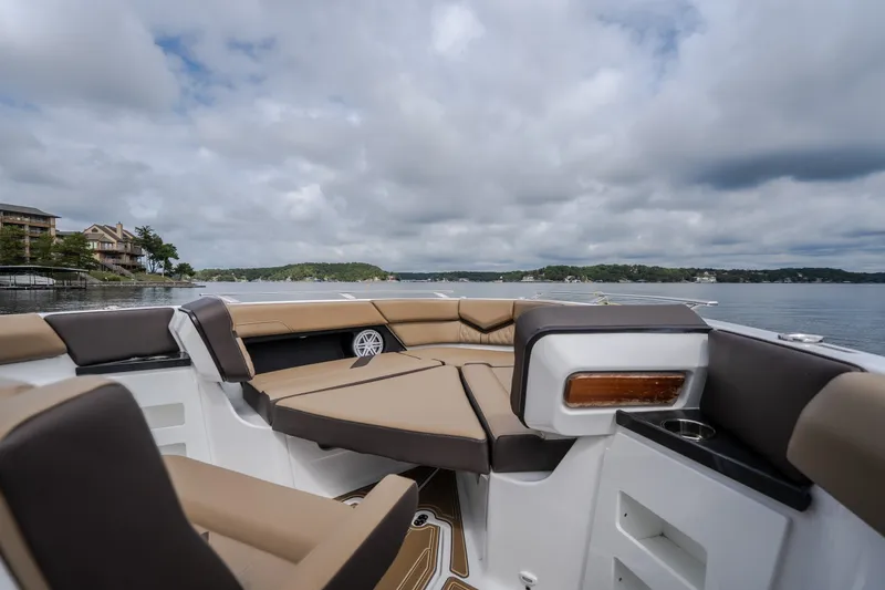 Slide: The Image of Luxurious seating on the 2026 Monterey Elite 30 OB boat, with scenic lake view. - 28