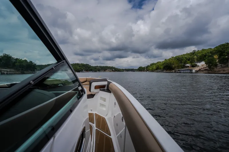 Slide: The Image of 2026 Monterey Elite 30 OB cruising on a scenic lake under cloudy skies. - 27