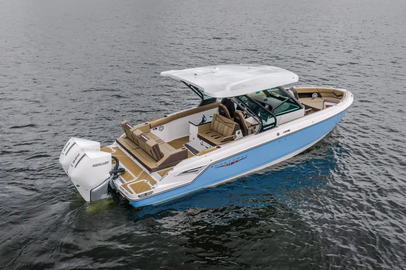 Slide: The Image of 2026 Monterey Elite 30 OB boat on water, featuring sleek design and spacious seating. - 4