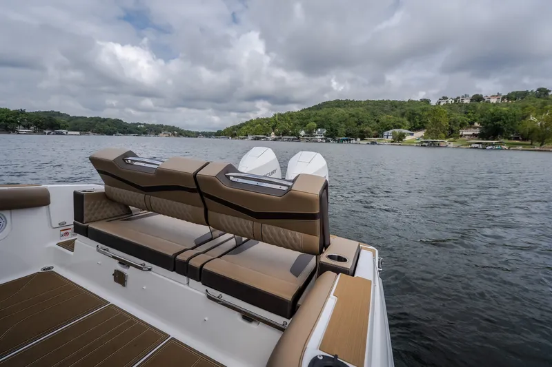 Slide: The Image of 2026 Monterey Elite 30 OB boat with luxurious seating on a scenic lake. - 42