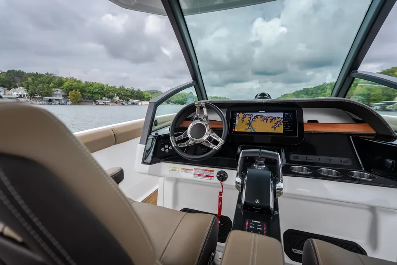 Slide: The Image of Interior view of 2026 Monterey Elite 30 OB boat cockpit with navigation display. - 14
