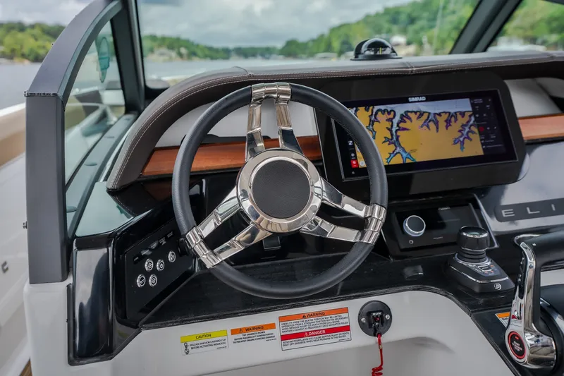 Slide: The Image of Steering wheel and navigation system of 2026 Monterey Elite 30 OB boat. - 15