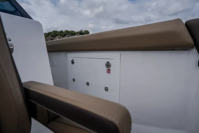 Slide: The Image of 2026 Monterey Elite 30 OB boat interior with beige seating and storage compartment. - 38