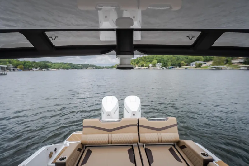 Slide: The Image of 2026 Monterey Elite 30 OB boat with dual engines on a serene lake. - 39