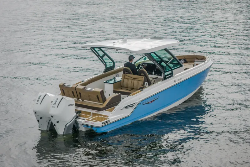 Slide: The Image of 2026 Monterey Elite 30 OB boat on water, featuring dual Mercury outboard engines. - 46