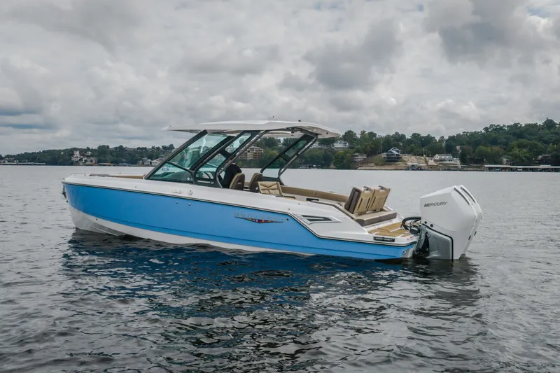 Slide: The Image of 2026 Monterey Elite 30 OB boat on a lake with cloudy skies. - 63