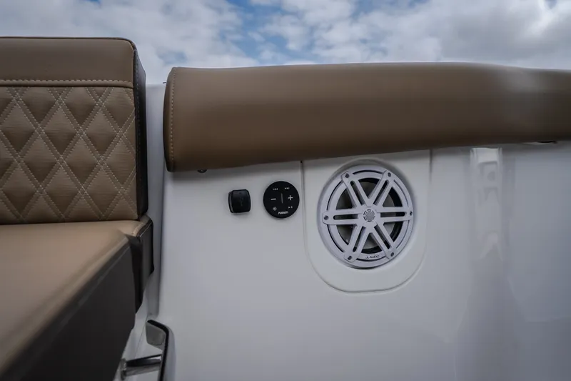 Slide: The Image of 2026 Monterey Elite 30 OB boat interior with speaker and cushioned seating. - 59
