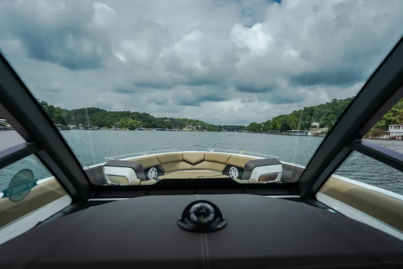 Slide: The Image of 2026 Monterey Elite 30 OB boat interior view on a scenic lake. - 19