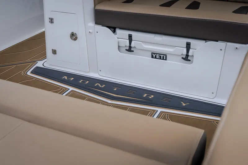 Slide: The Image of Interior of 2026 Monterey Elite 30 OB boat with Yeti cooler and branded flooring. - 8