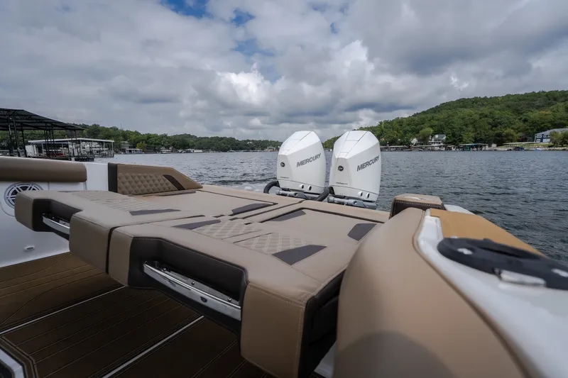 Slide: The Image of 2026 Monterey Elite 30 OB boat with dual Mercury outboard engines on a scenic lake. - 41