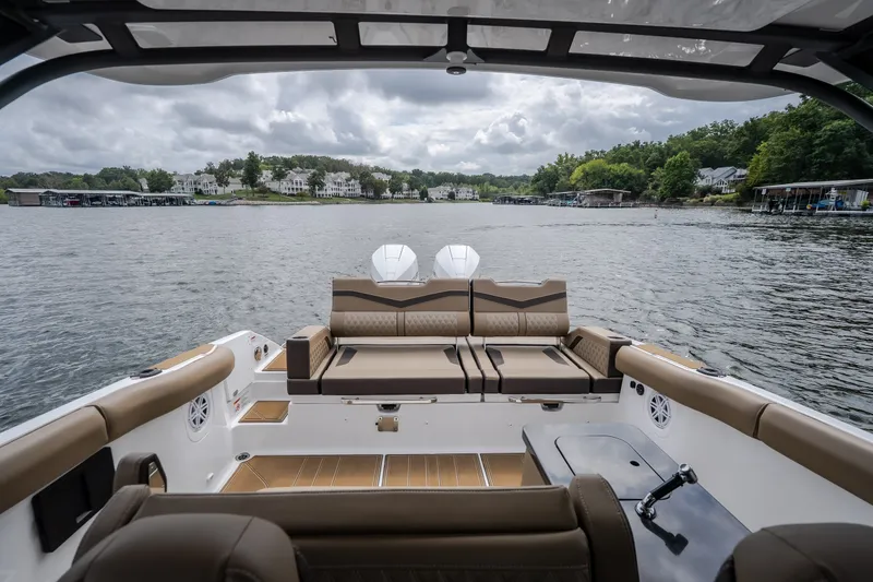Slide: The Image of 2026 Monterey Elite 30 OB boat interior with lake view, featuring luxurious seating and modern design. - 26