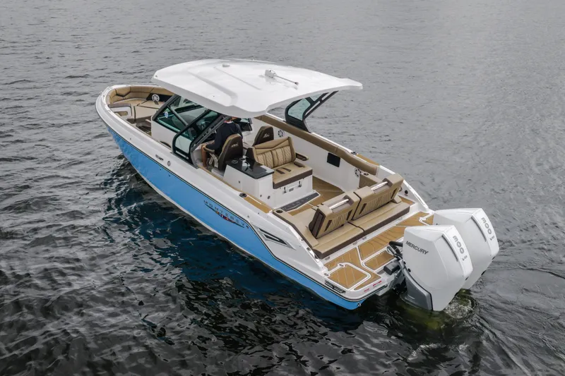 Slide: The Image of 2026 Monterey Elite 30 OB boat on water, featuring dual Mercury outboard engines. - 3
