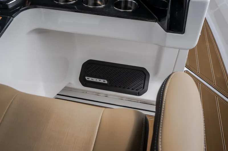 Slide: The Image of Interior of 2026 Monterey Elite 30 OB boat with tan seating and cup holders. - 60