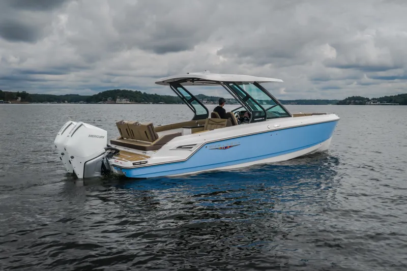 Slide: The Image of 2026 Monterey Elite 30 OB boat on a lake under cloudy skies. - 62