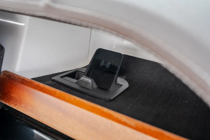 Slide: The Image of Wireless charging station on 2026 Monterey Elite 30 OB boat interior. - 24