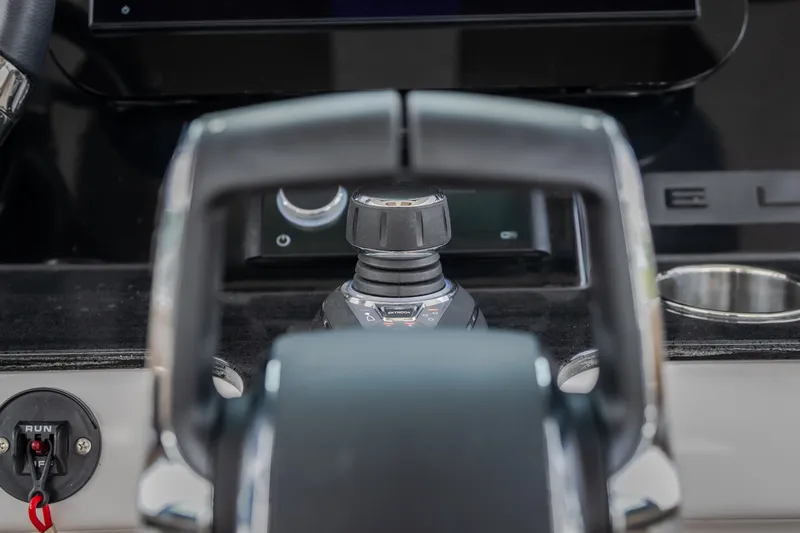 Slide: The Image of Close-up of 2026 Monterey Elite 30 OB boat control panel with joystick and throttle. - 17