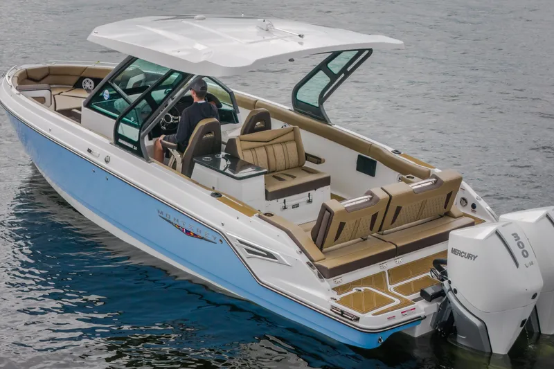 Slide: The Image of 2026 Monterey Elite 30 OB boat on water, featuring sleek design and Mercury outboard engines. - 45