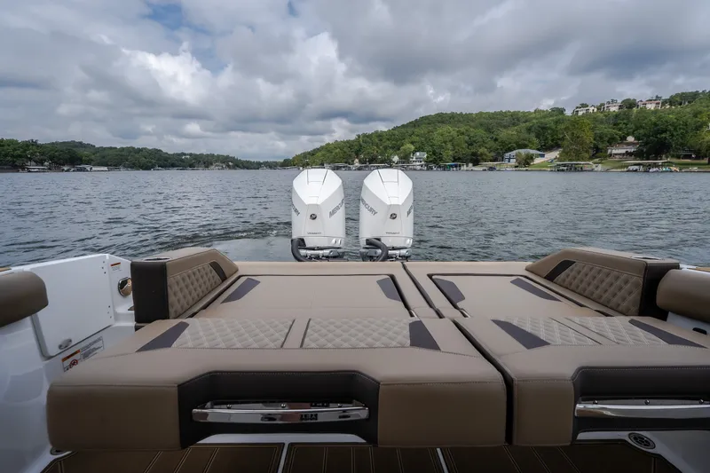 Slide: The Image of 2026 Monterey Elite 30 OB boat with twin engines on a scenic lake. - 40