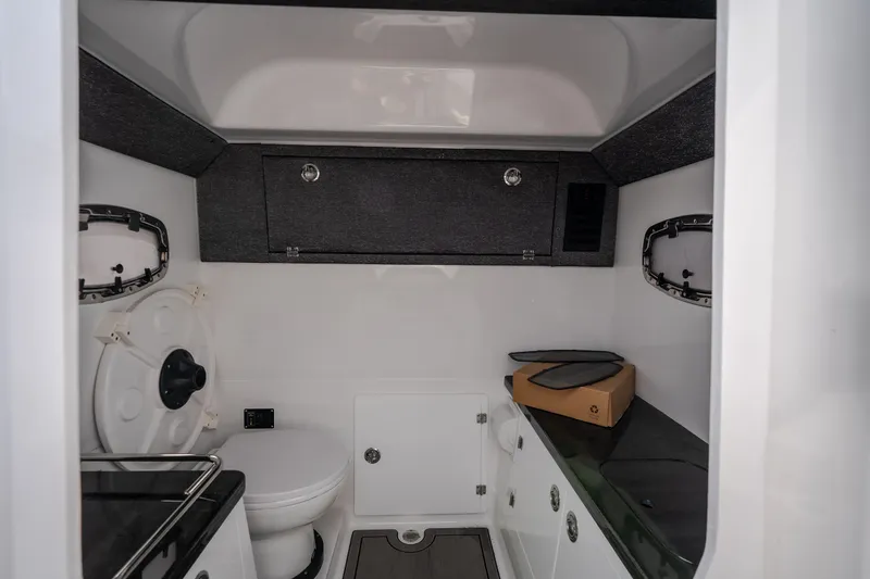Slide: The Image of Interior of 2026 Monterey Elite 30 OB boat, featuring a compact bathroom with modern amenities. - 37