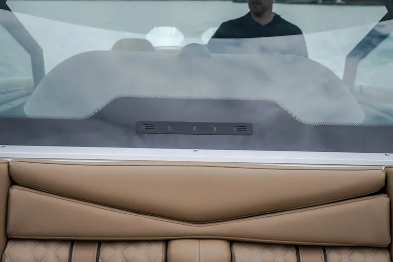 Slide: The Image of 2026 Monterey Elite 30 OB boat interior with beige leather seating and windshield. - 35