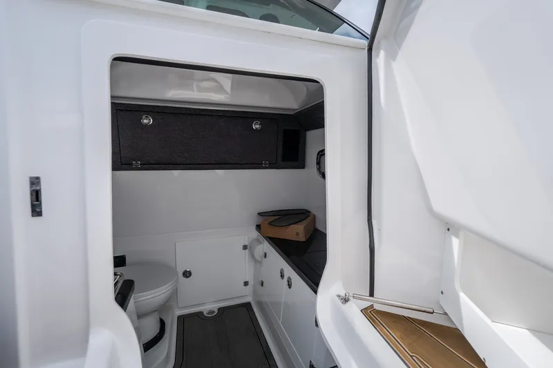 Slide: The Image of Interior of 2026 Monterey Elite 30 OB boat featuring a compact bathroom. - 36