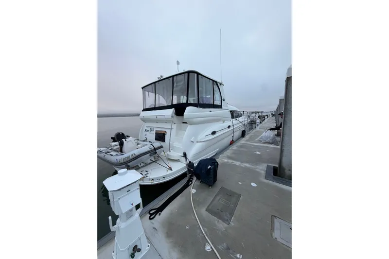 Slide: The Image of 2005 Sea Ray 480 Motor Yacht docked at marina, overcast sky. - 2