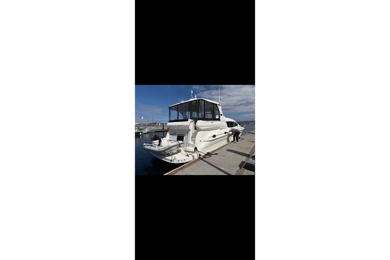 Slide: The Image of 2005 Sea Ray 480 Motor Yacht docked at marina under clear sky. - 3