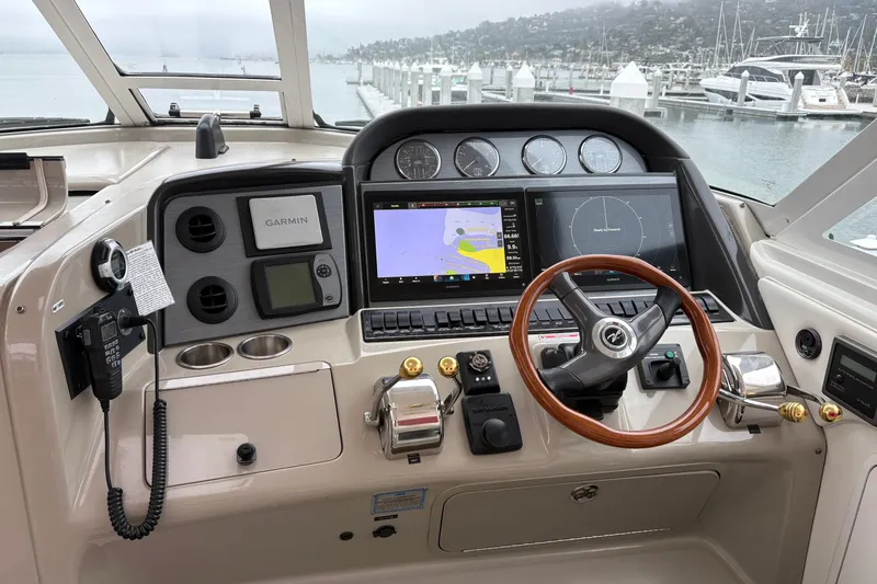 Slide: The Image of 2005 Sea Ray 480 Motor Yacht helm with Garmin navigation, steering wheel, and control panel. - 9