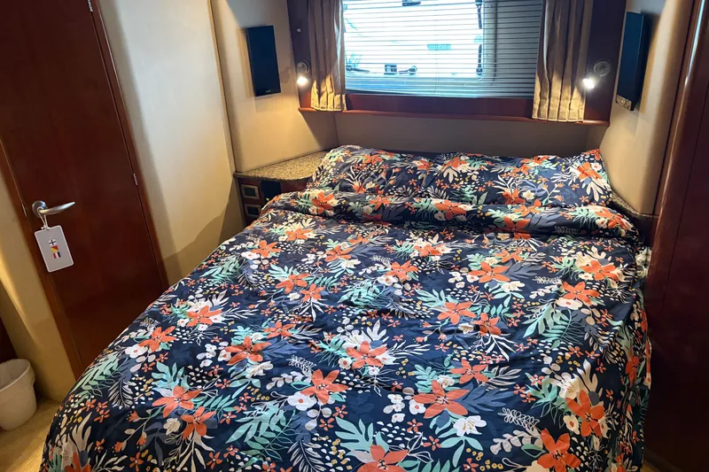 Slide: The Image of Luxurious bedroom in 2005 Sea Ray 480 Motor Yacht with floral bedding and ambient lighting. - 13