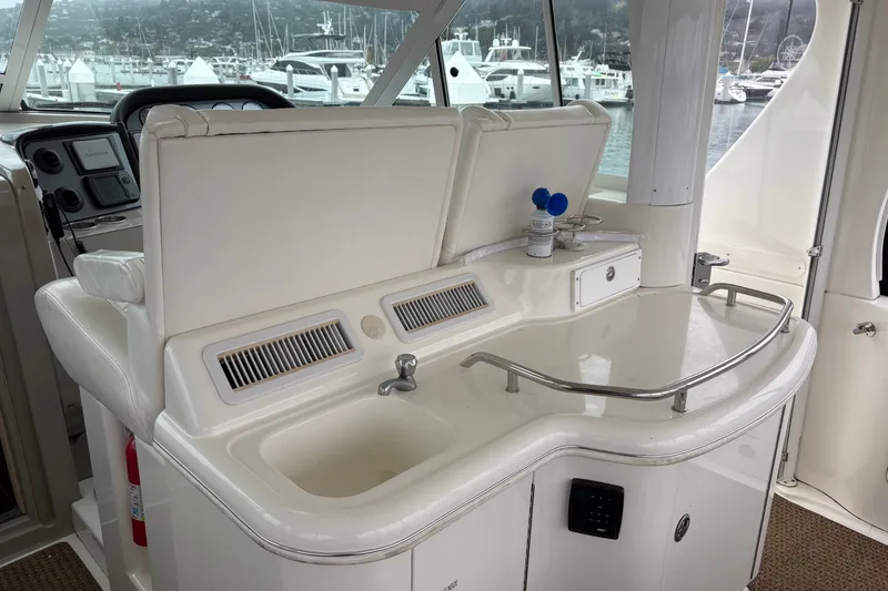 Slide: The Image of 2005 Sea Ray 480 Motor Yacht interior with sink and control panel, docked at marina. - 5