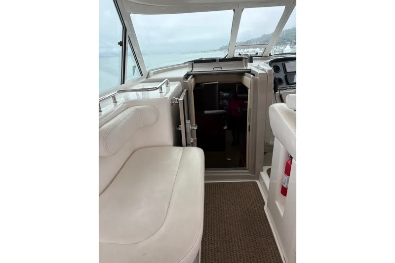 Slide: The Image of Interior view of 2005 Sea Ray 480 Motor Yacht cockpit with seating and navigation area. - 7
