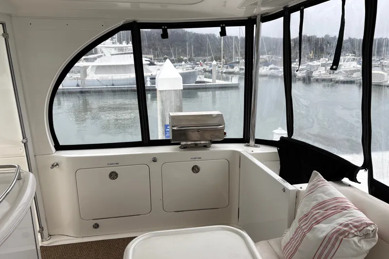 Slide: The Image of 2005 Sea Ray 480 Motor Yacht interior with marina view, featuring seating and a grill. - 4
