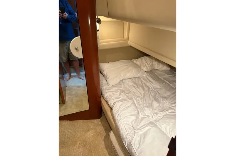 Slide: The Image of Cozy bedroom interior of 2005 Sea Ray 480 Motor Yacht with comfortable bedding. - 12
