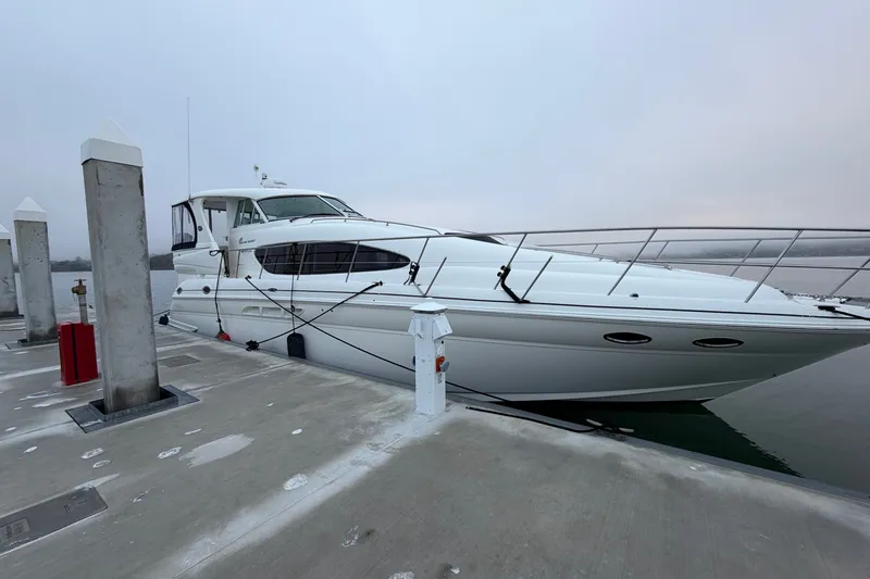 Slide: The Image of 2005 Sea Ray 480 Motor Yacht docked at a marina on a cloudy day. - 1