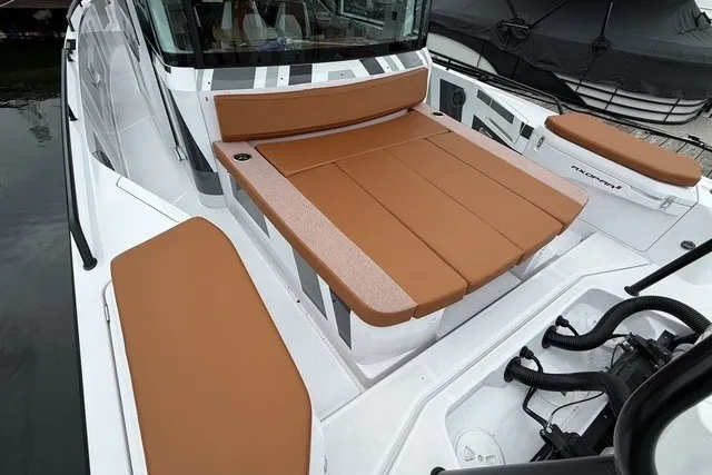 Slide: The Image of 2025 Axopar 37 XC Cross Cabin with brown seating and sleek design. - 14