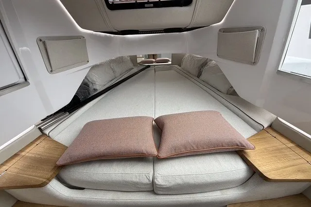 Slide: The Image of Interior of 2025 Axopar 37 XC Cross Cabin with cozy bedding and cushions. - 30