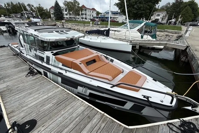 Slide: The Image of 2025 Axopar 37 XC Cross Cabin docked at a marina, featuring sleek design and modern amenities. - 7
