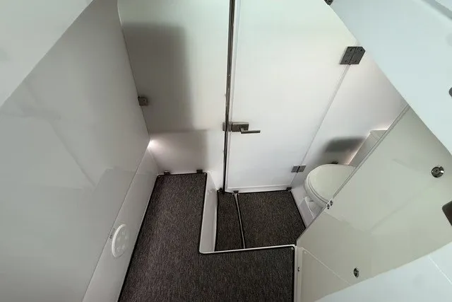 Slide: The Image of 2025 Axopar 37 XC Cross Cabin bathroom interior with modern design and compact layout. - 26