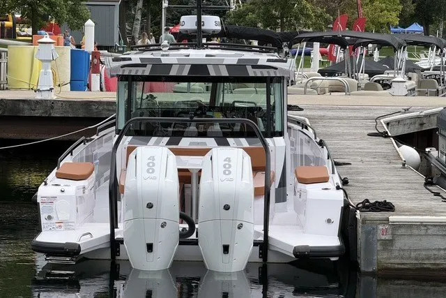 Slide: The Image of 2025 Axopar 37 XC Cross Cabin with twin 400 V8 engines docked at marina. - 3