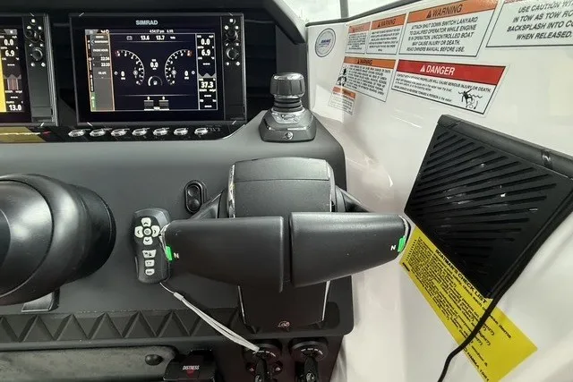 Slide: The Image of Control panel of 2025 Axopar 37 XC Cross Cabin with navigation display and steering wheel. - 19